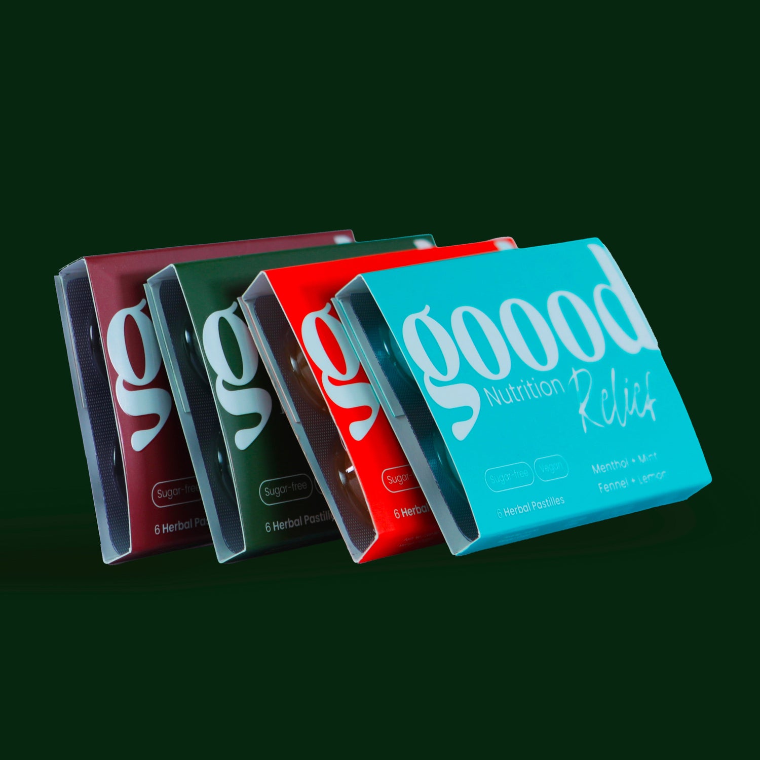 goood pastilles, four lozenges in a dark green background